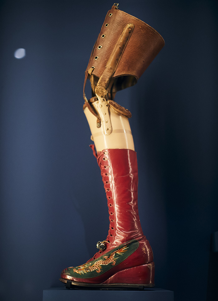Prótesis de pierna roja con una bota decorada